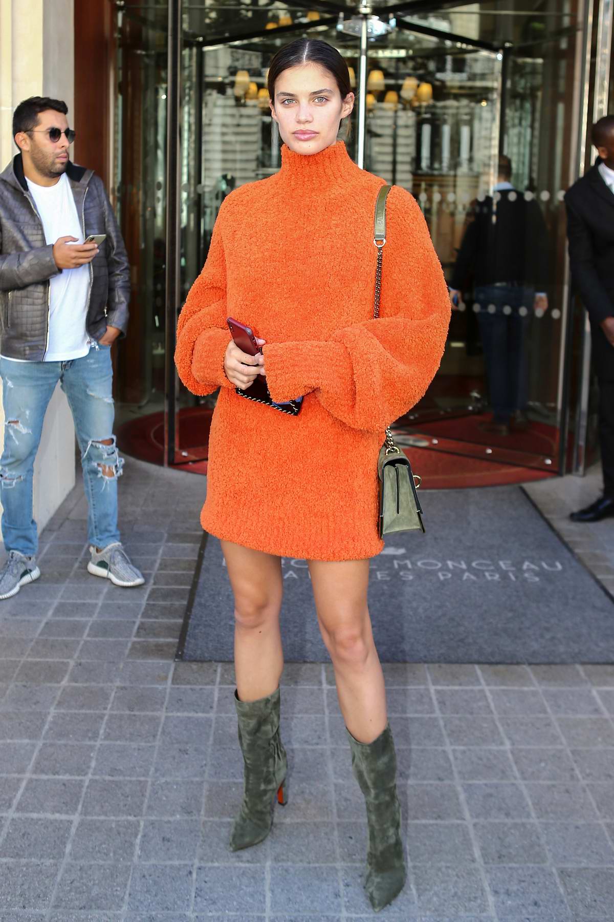 sara sampaio wears an orange dress with olive green suede boots as she ...