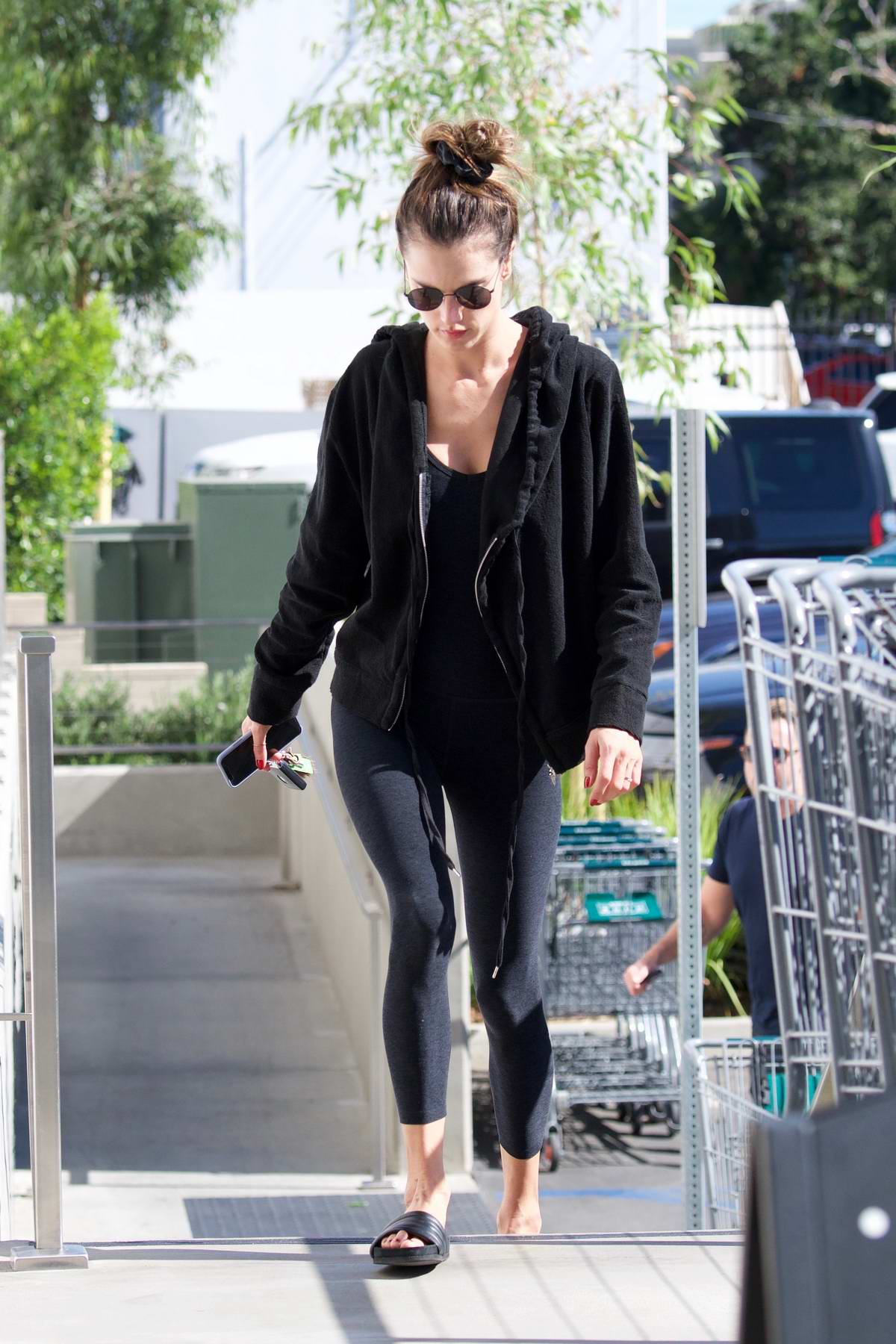Eiza Gonzalez looks amazing in a black top and olive green leggings during  a coffee run