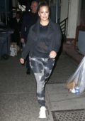 Ashley Graham rocks a patterned leggings with a black top and jacket as she walks back to her apartment in New York City