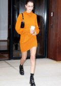 Bella Hadid steps out wearing an orange dress in New York City