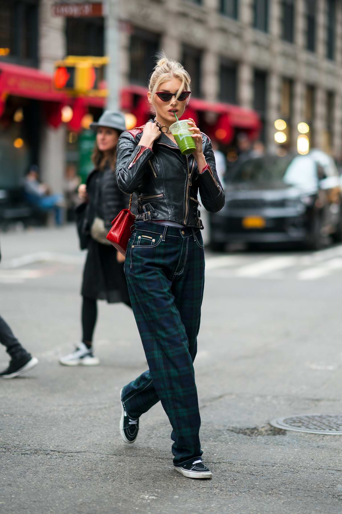 Elsa Hosk looks stylish in a black leather jacket and plaid pants with a red Chanel handbag ...