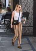 Emma Roberts wears white tank top and colorful striped pants as she leaves the 901 salon in West Hollywood, Los Angeles