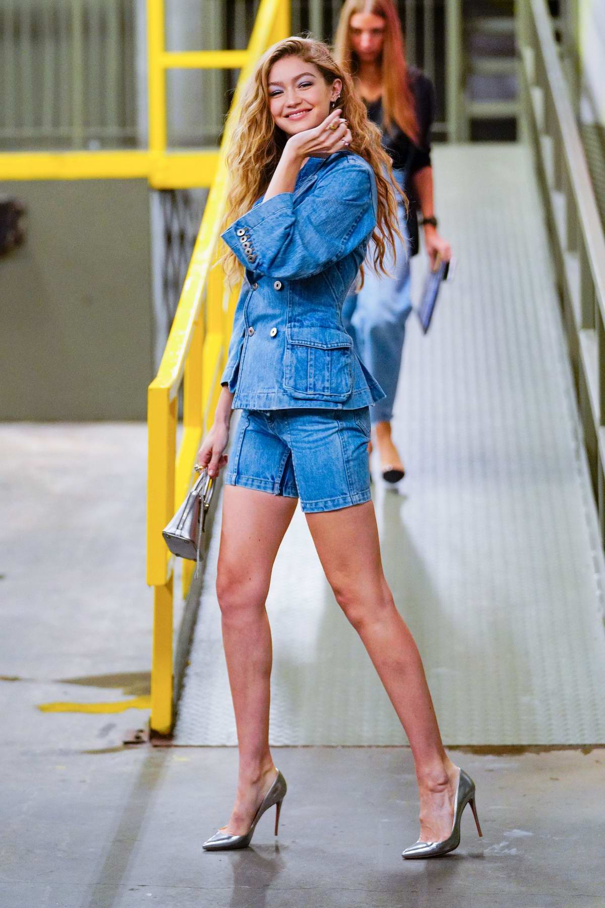 Alessandra Ambrosio wears a white top and aqua blue leggings as