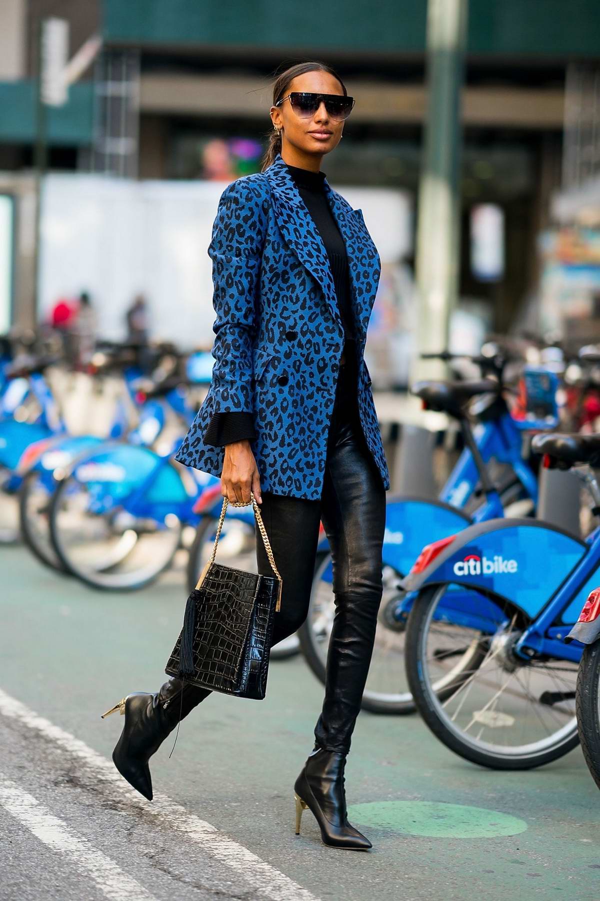 jasmine tookes wears an animal print blue jacket with leather pants and ...