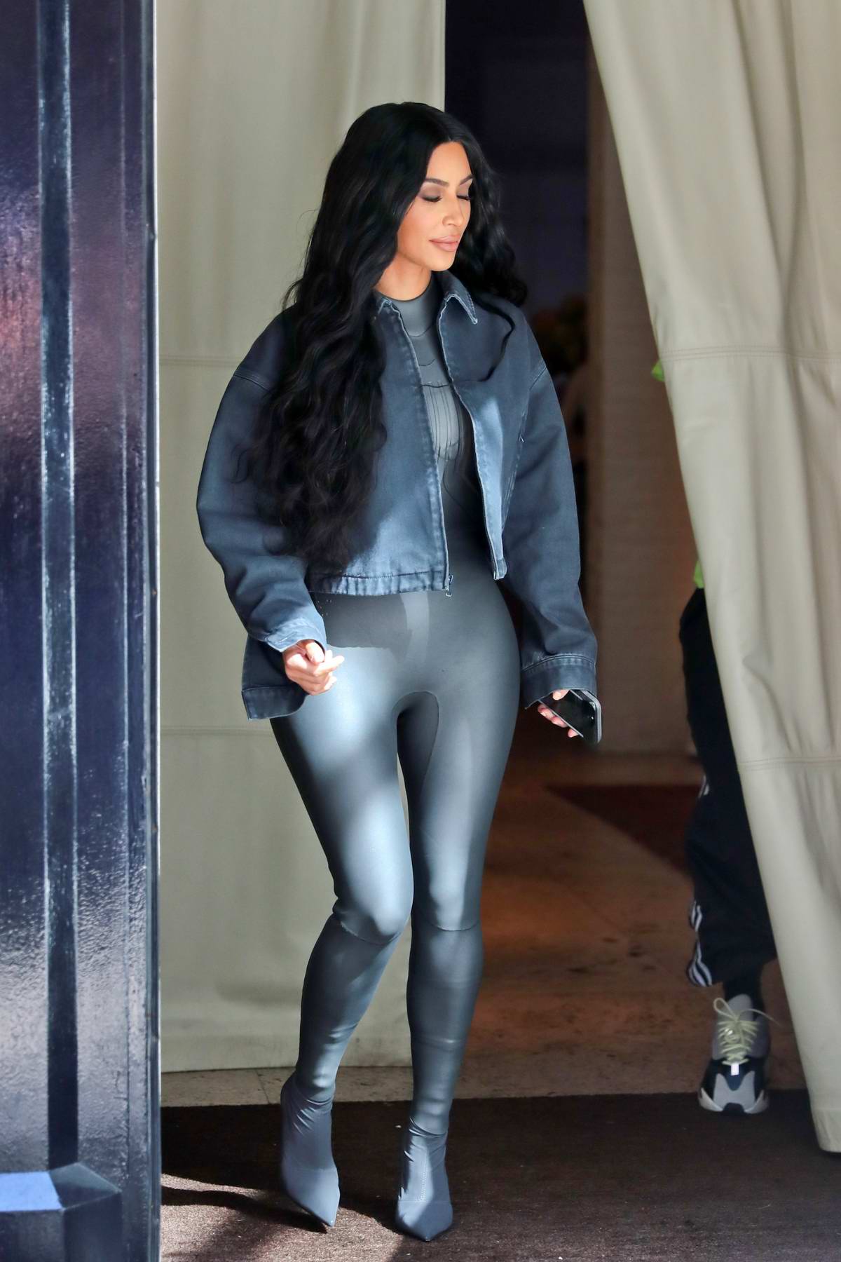 Kim Kardashian rocks dark grey leather bodysuit with matching