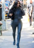 Kim Kardashian rocks dark grey leather bodysuit with matching boots and cropped denim jacket while out in Tribeca, New York City