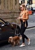 Kimberley Garner walks her dog before driving away her Ferrari in Kensington, UK