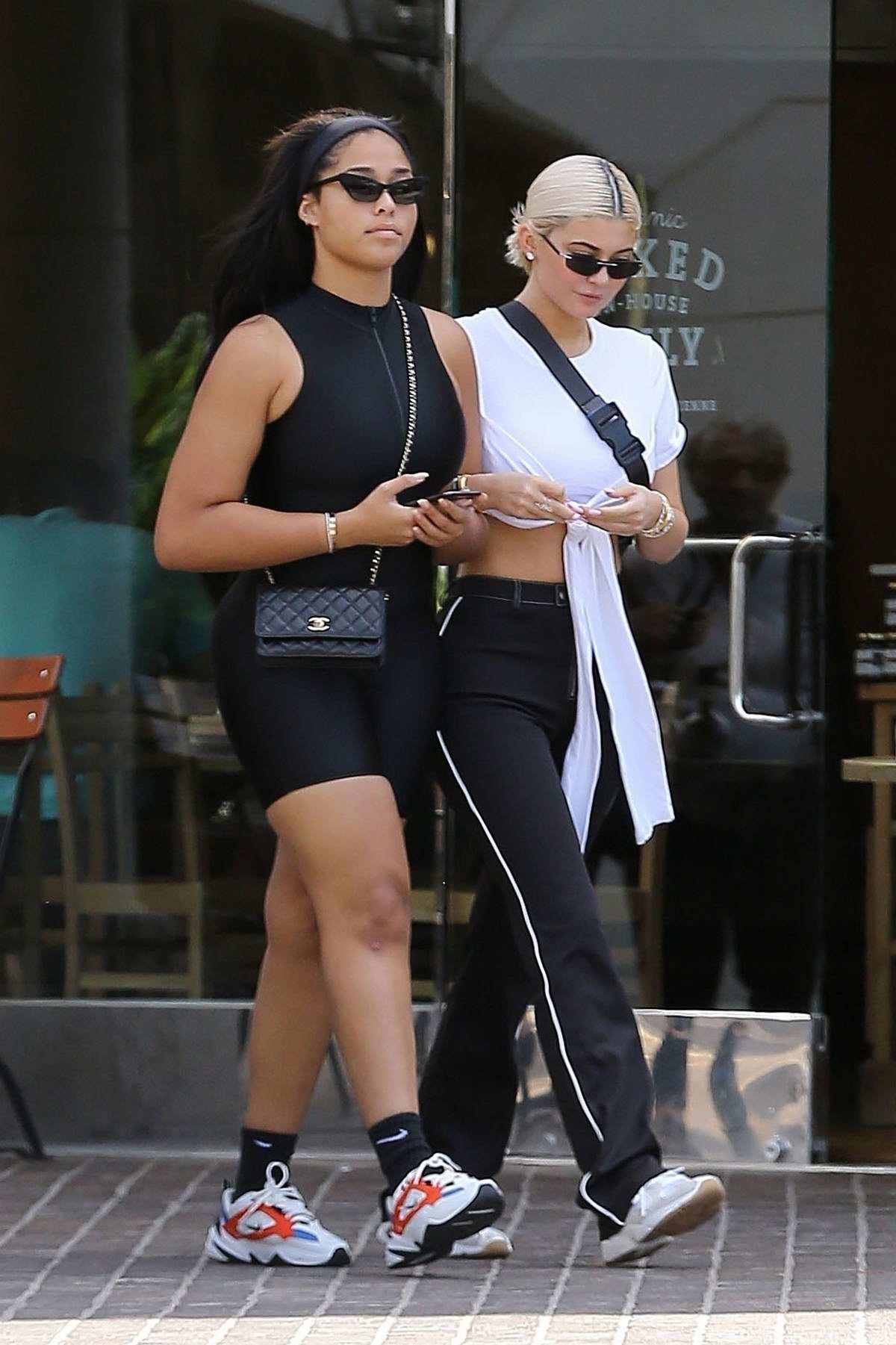 Kylie Jenner wore a white crop top, black pants and sneakers while