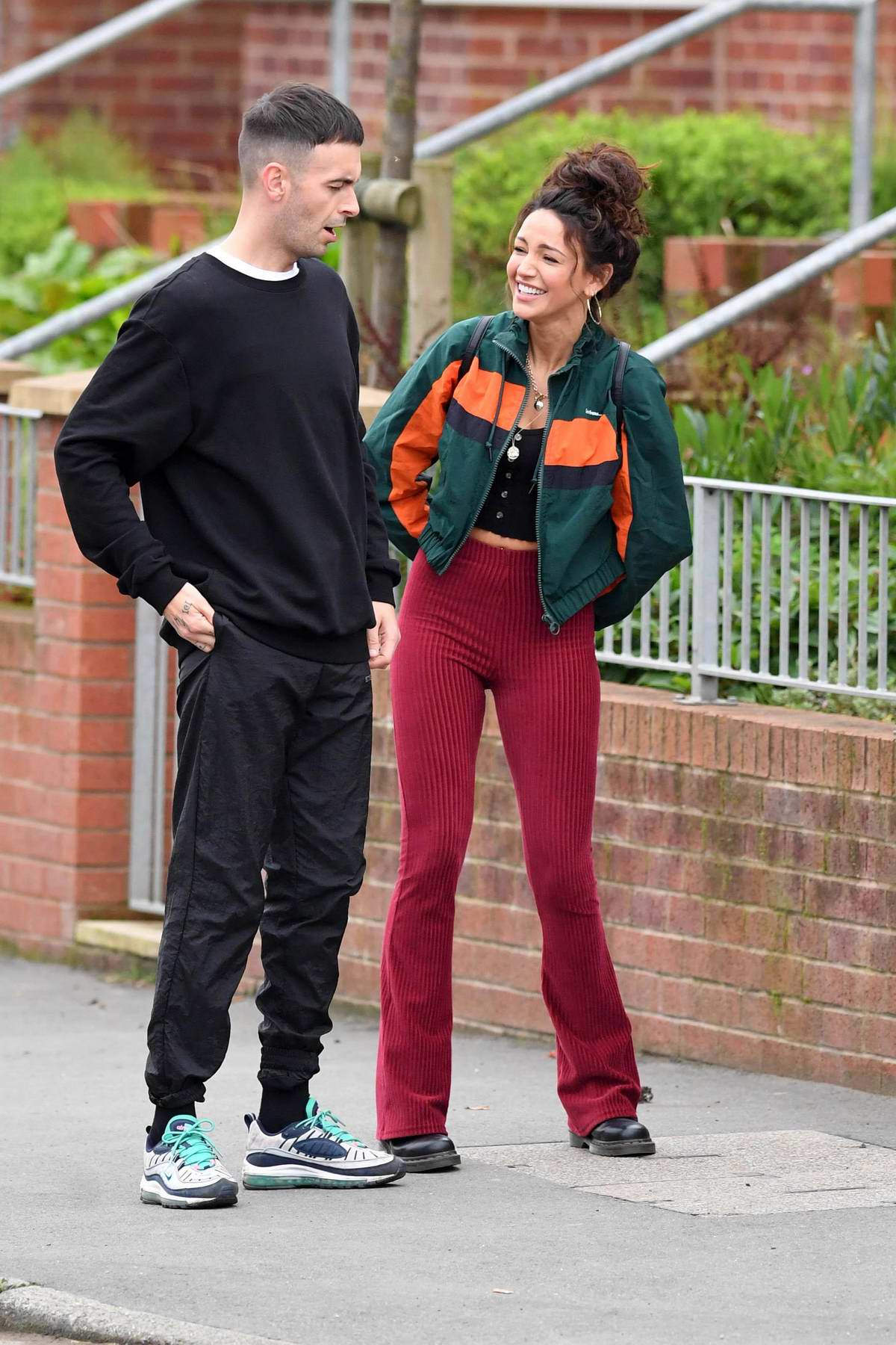 Michelle Keegan dons a green and orange jacket and maroon corduroy