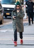 Sienna Miller stays warm in a fur lined green parka while sipping on a hot coffee as she steps out in New York City