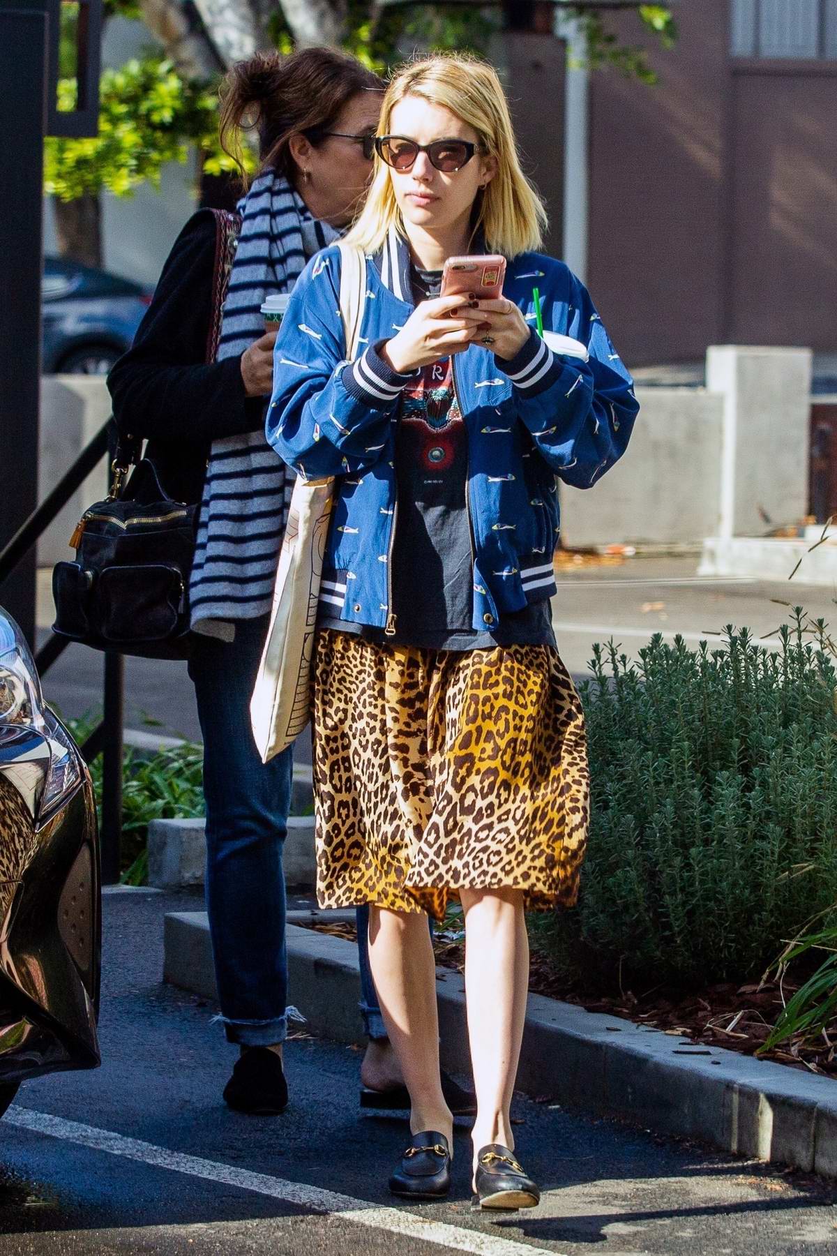 emma roberts wore a leopard print skirt and blue jacket while out with ...