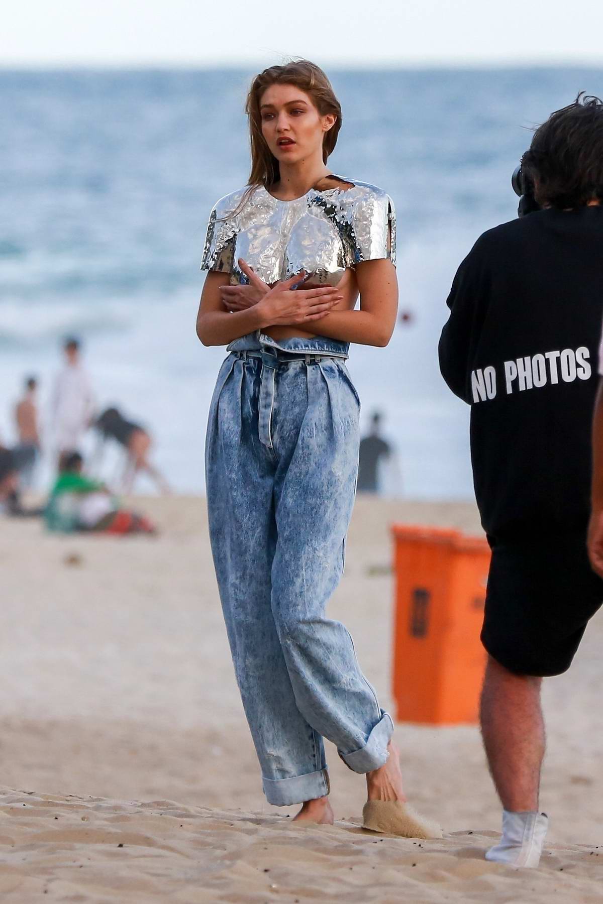 gigi hadid poses in a metalic crop top and loose-fitting jeans during a  photo shoot at the beach of ipanema in rio, brazil-201018_4