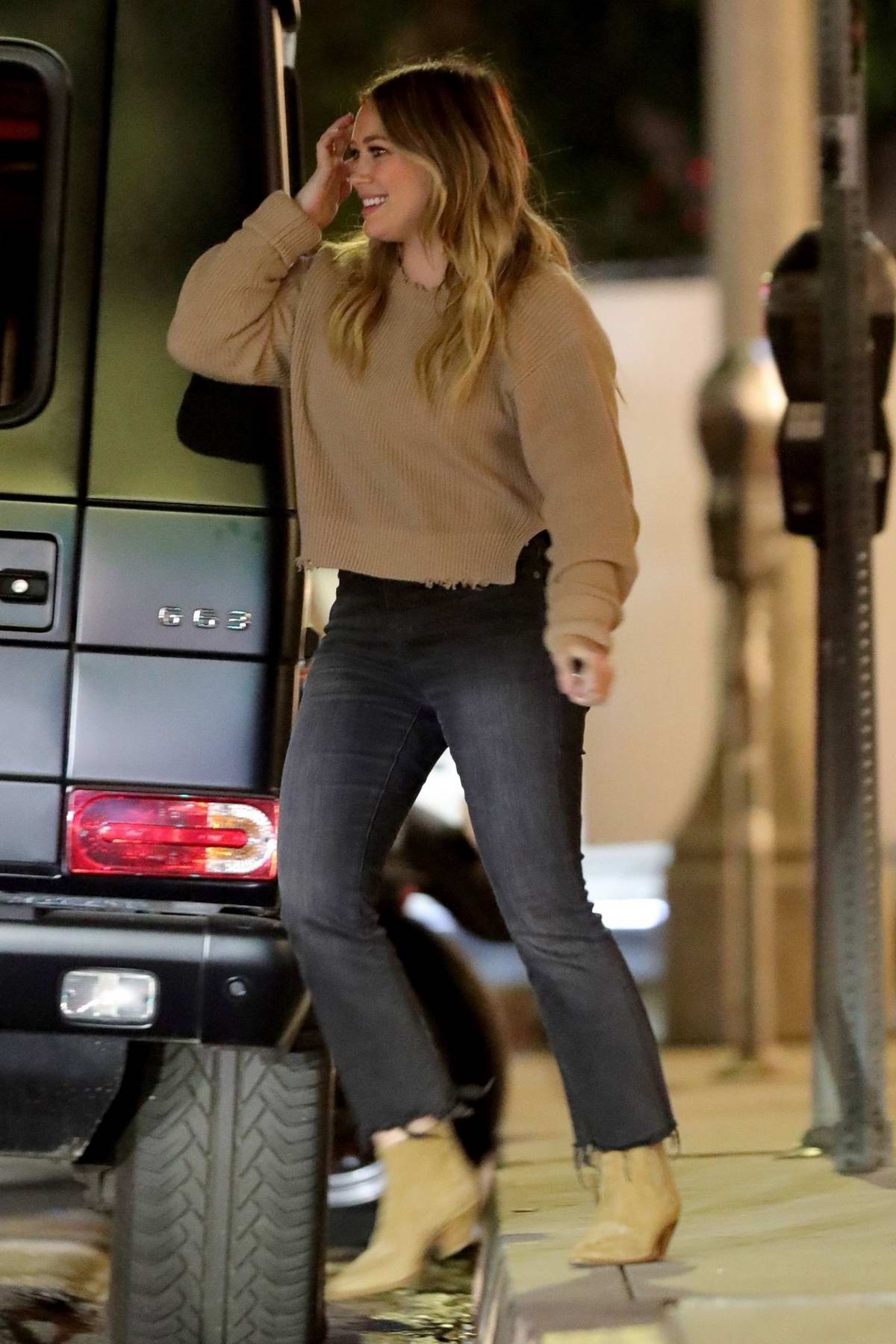 Charli D'Amelio wears a grey tee and black leggings while spotted