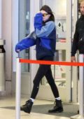 Kendall Jenner rocks an Adidas sweatshirt and leggings as she arrives to catch an early morning flight at LAX in Los Angeles
