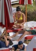 Dua Lipa spotted in a yellow bikini as she lounges by the pool with boyfriend Isaac Carew and sister Rina in Miami, Florida