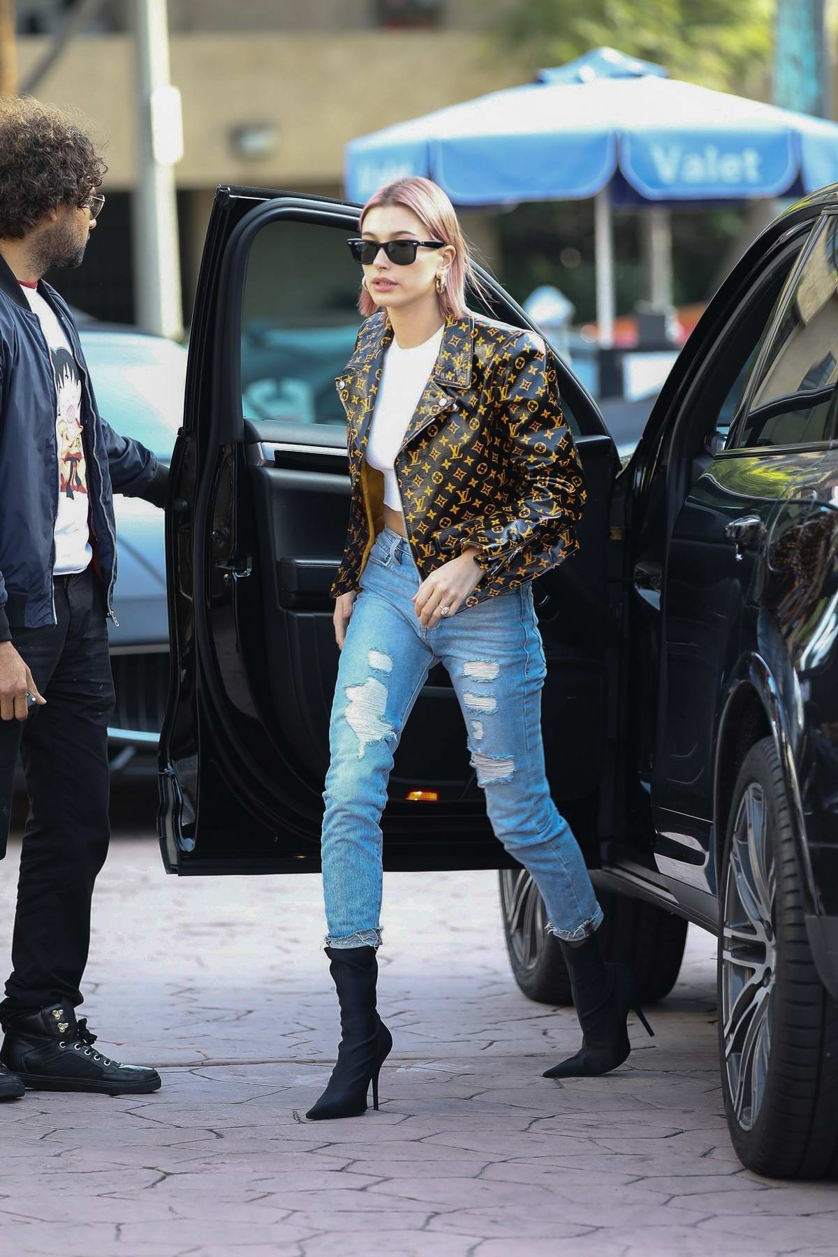 Hailey Baldwin Bieber looks trendy in a Louis Vuitton jacket while stopping  by at Alfred Coffee