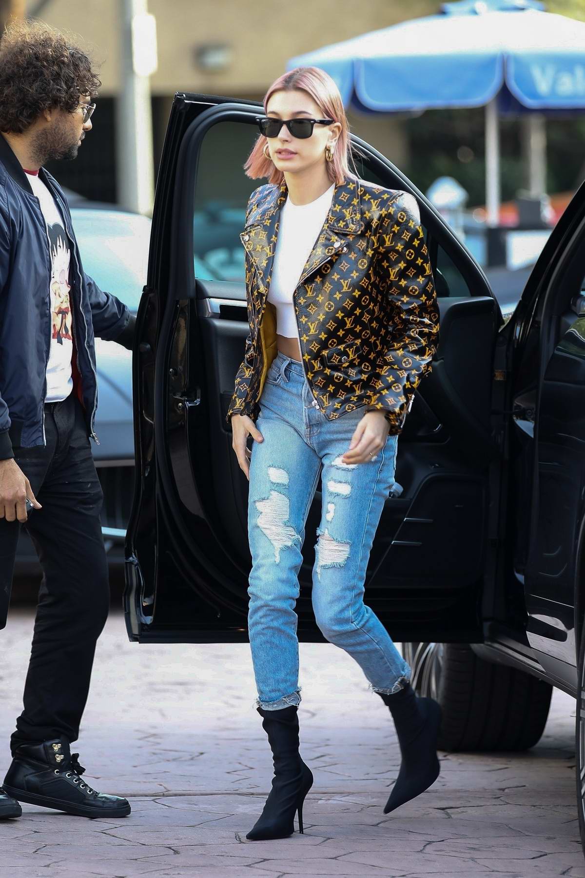 Hailey Baldwin Bieber looks trendy in a Louis Vuitton jacket while