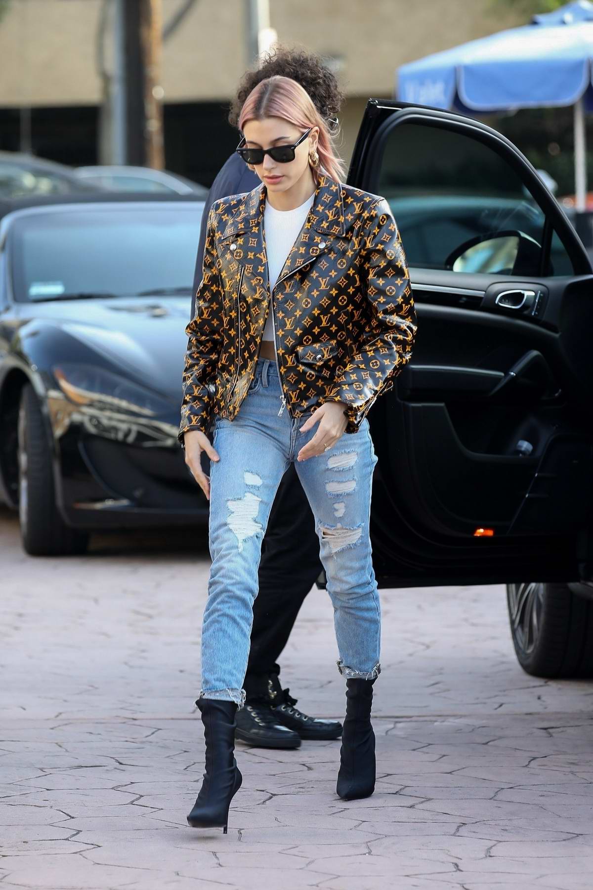 Hailey Baldwin Bieber looks trendy in a Louis Vuitton jacket while stopping  by at Alfred Coffee