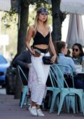 Kimberley Garner rocks a pair of low-slung white jeans over a black bikini while for lunch with friends in Miami, Florida