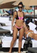 Metisha Schaefer puts on a pink and black bikini while enjoying the sun on Miami Beach, Florida
