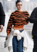 Bella Hadid looks trendy in an orange and black animal print sweater and flared jeans while out and about in Milan, UK