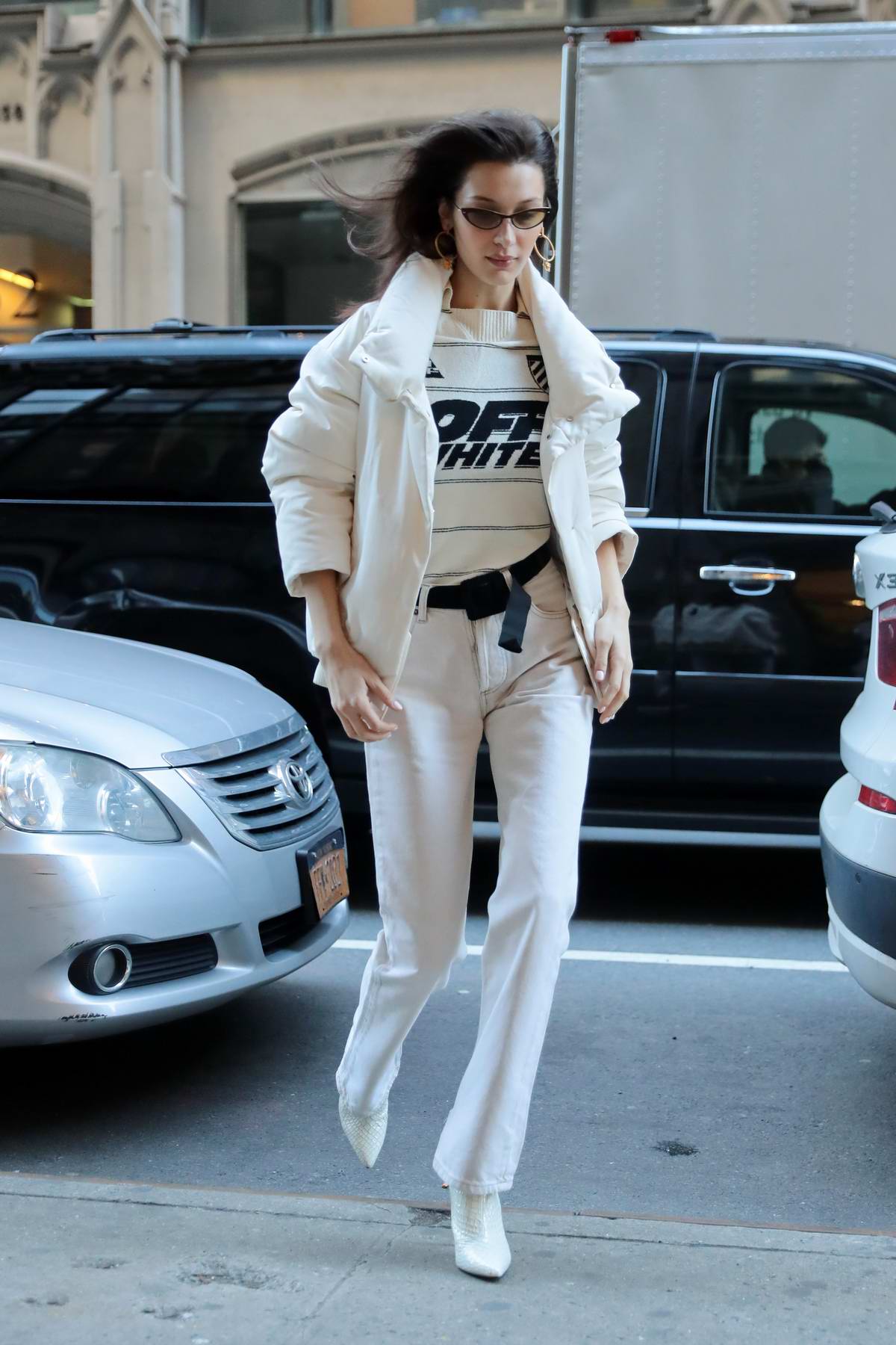 bella hadid rocks an 'off white' sweater with an all white ensemble as ...