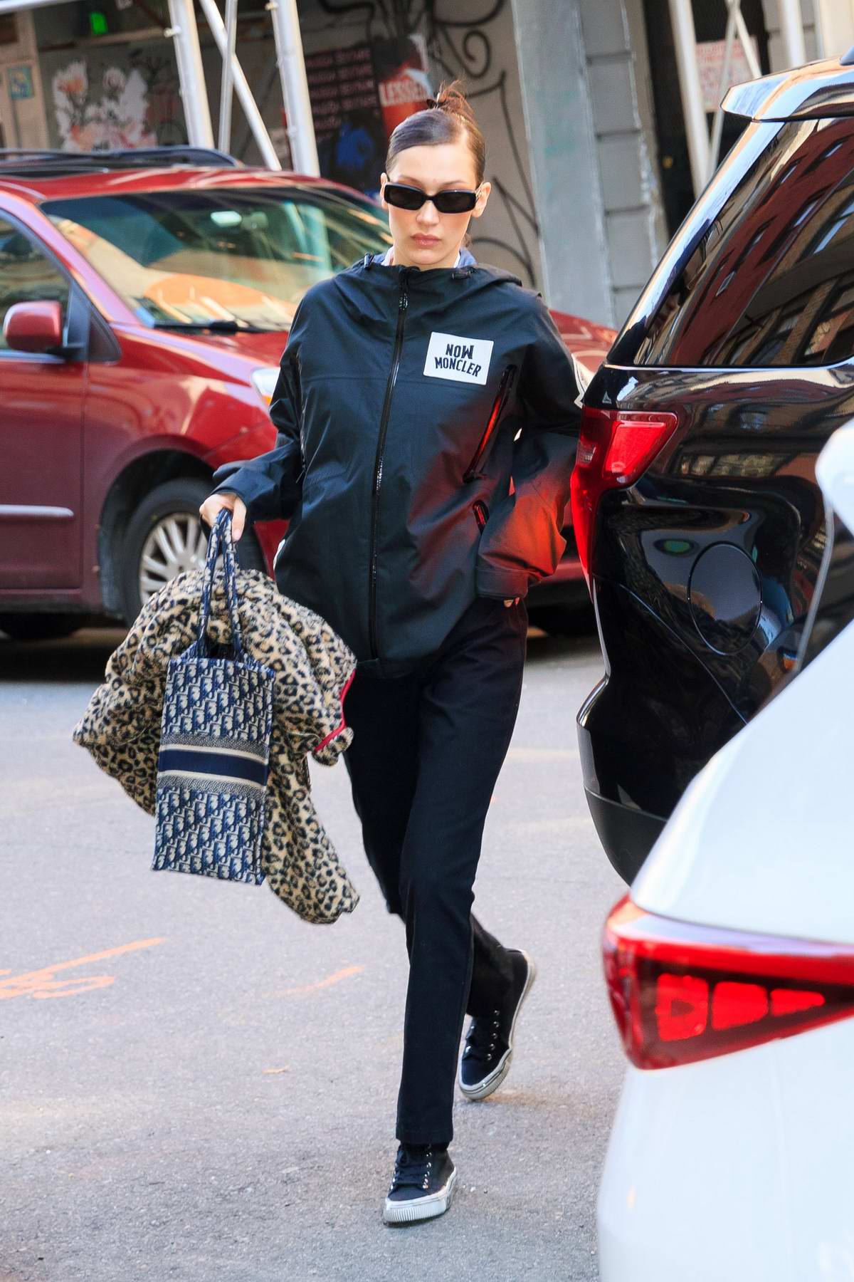 Bella Hadid wears Moncler and takes her own bags into a building during ...