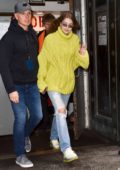 Gigi Hadid stands out in an lime green knit sweater as she arrives at Michael Kors fashion show during New York Fashion Week in New York City
