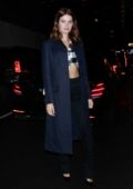 Isabeli Fontana looks chic in a navy blue blazer with a plaid crop top and black trousers during a night out in New York City