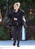 Kaley Cuoco wore a black jacket with matching leggings and trainers while she grabs lunch with a friend at the Sun Cafe in Los Angeles
