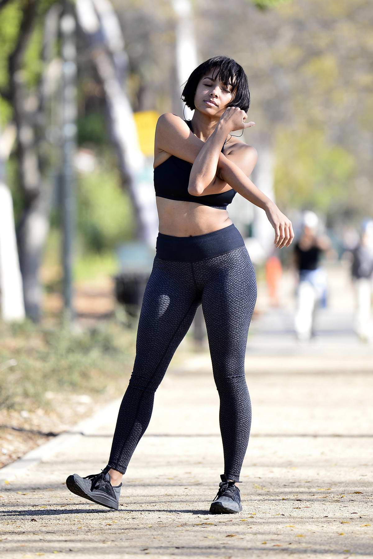 Kat Graham shows off her toned body in a black Under Armour sports bra and  leggings