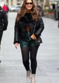 Kelly Brook wears a black fur and leather jacket with green shorts as she heads to the Heart Radio studios in London, UK