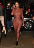 Kim Kardashian wore a brown snakeskin print dress as she arrives for dinner Kourtney Kardashian at Milos in New York City