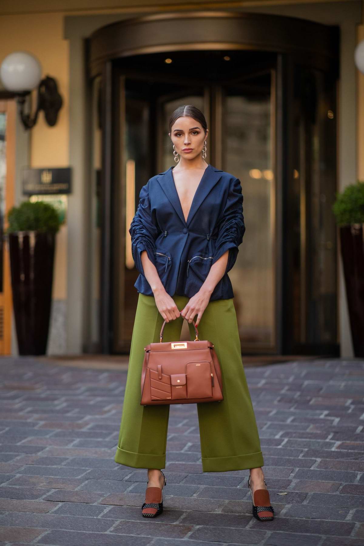 Olivia Culpo shows off her chic style in a blue blazer and rolled-up lime- green