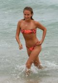 Sailor Brinkley Cook wears an orange snakeskin print bikini during a beach day in Miami, Florida