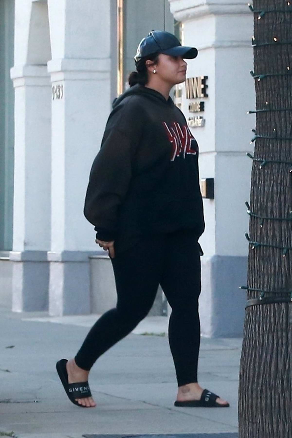 Demi Lovato keeps it casual with a black hoodie and leggings as she steps  out for