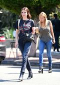 Emma Roberts smiles for the camera as she steps out in a blue tee and jeans in Los Angeles