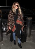 Fergie rocks a Fendi poncho for a flight out of LAX Airport in Los Angeles