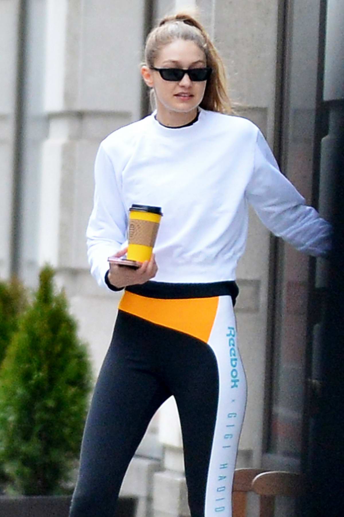 gigi hadid sports her own brand of reebok tights while exiting a