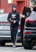 Katy Perry spotted in her black Adidas hoodie and leggings while out getting some dinner to-go at Larchmont Village in Los Angeles