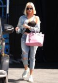 Khloe Kardashian dons denim jacket with ripped jeans and sneakers as she leaves a studio in Los Angeles