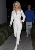 Lottie Moss arrives in a white jumpsuit and matching white boots for a bite with friends at Gracias Madre in West Hollywood, Los Angeles