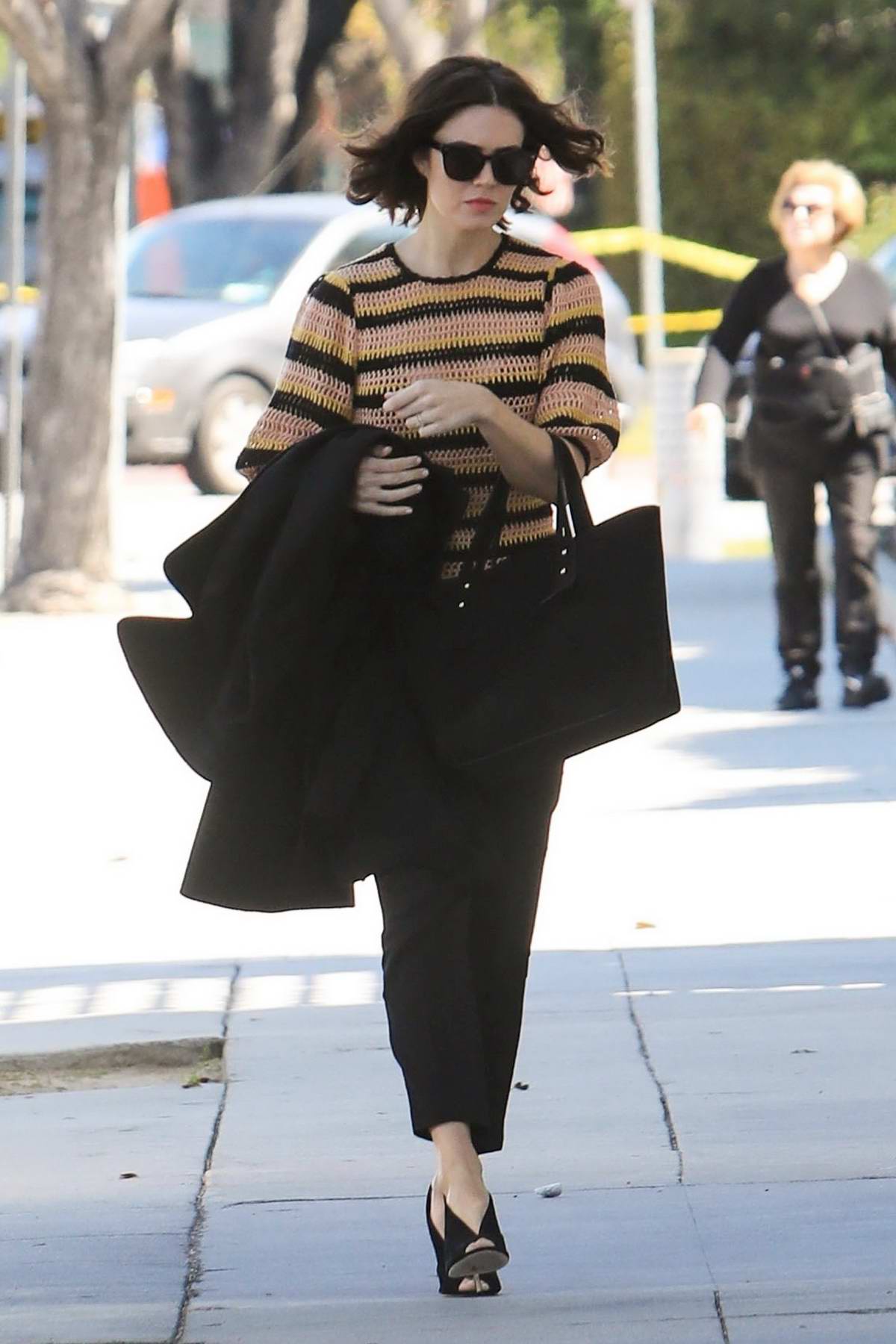 Mandy Moore steps out in a striped knitted sweater and black trousers ...