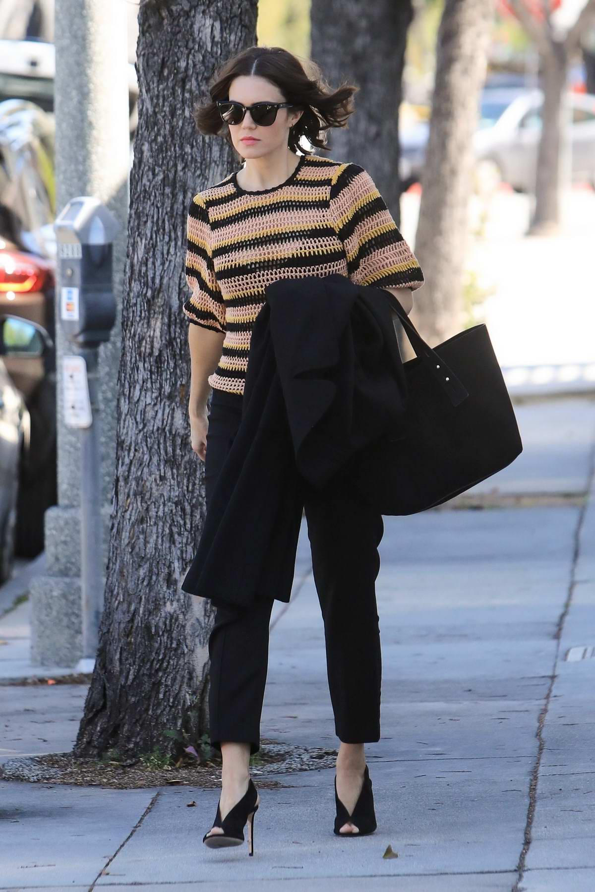 mandy moore steps out in a striped knitted sweater and black trousers ...