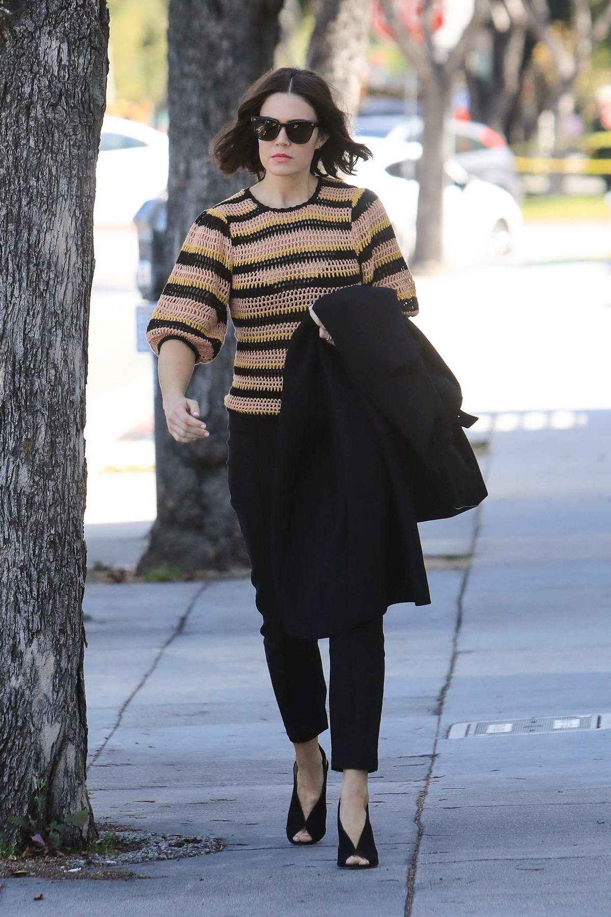 mandy moore steps out in a striped knitted sweater and black trousers ...