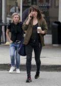 Milla Jovovich chats on her phone during a coffee run in Los Angeles