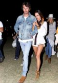 Alessandra Ambrosio holds on tight to Nicolo Oddi while out during Coachella in Indio, California