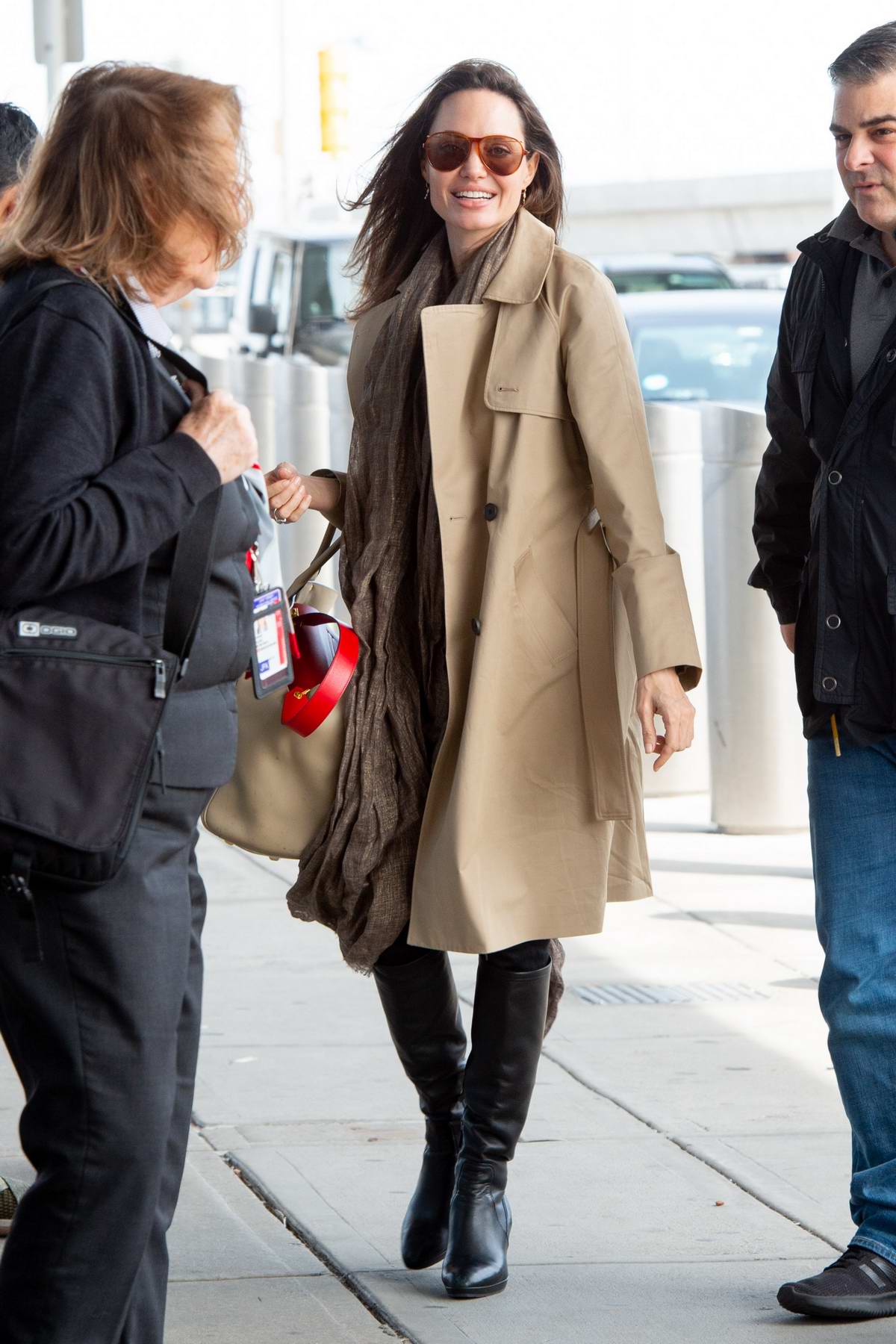 Angelina Jolie waves for the camera as she arrives at JFK Airport in New  York City