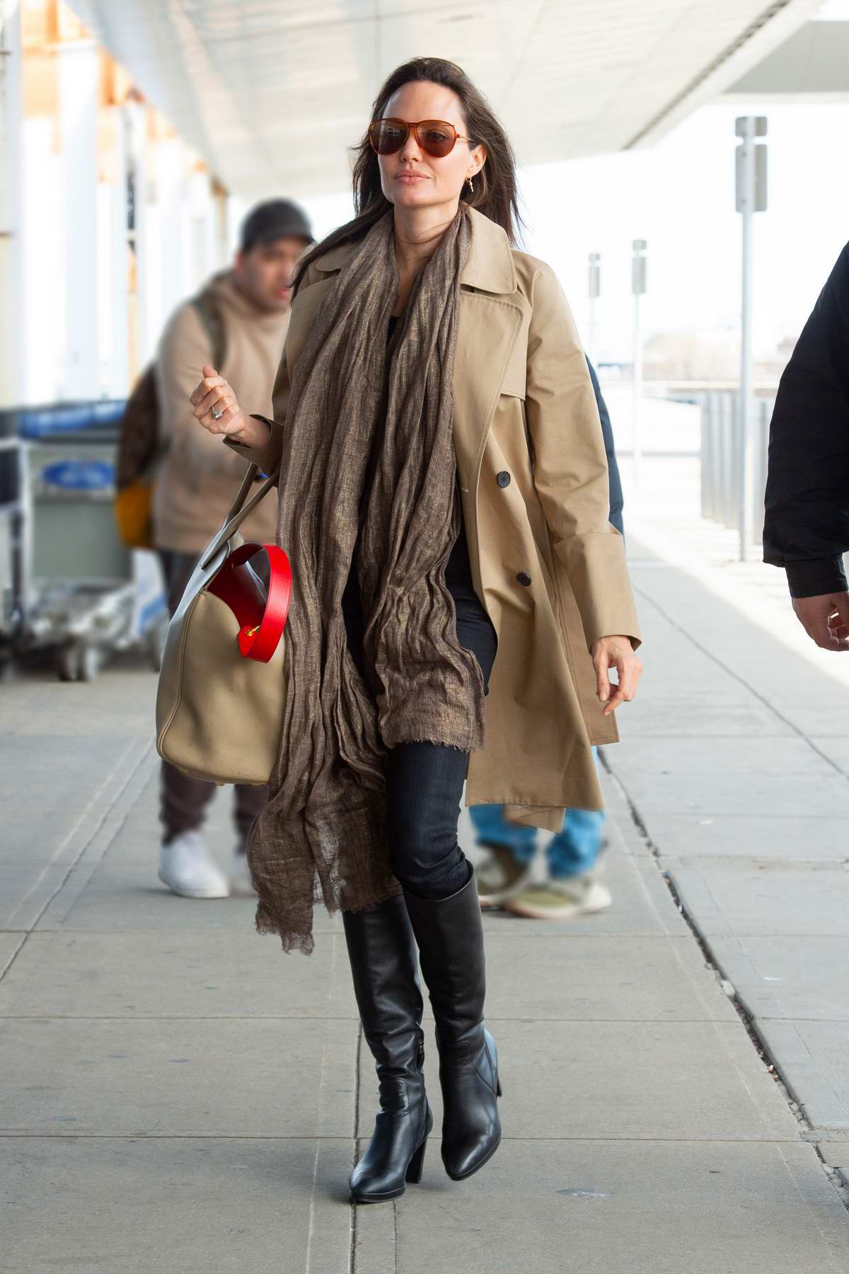 Angelina Jolie waves for the camera as she arrives at JFK Airport in New  York City