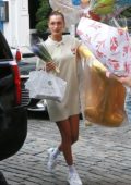 Bella Hadid arrives with birthday balloons and flowers at Gigi’s apartment in New York City